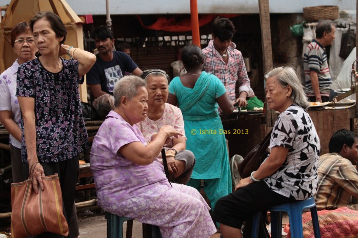 Residents of old china-town at the daily bazaar that assembles in the morning.